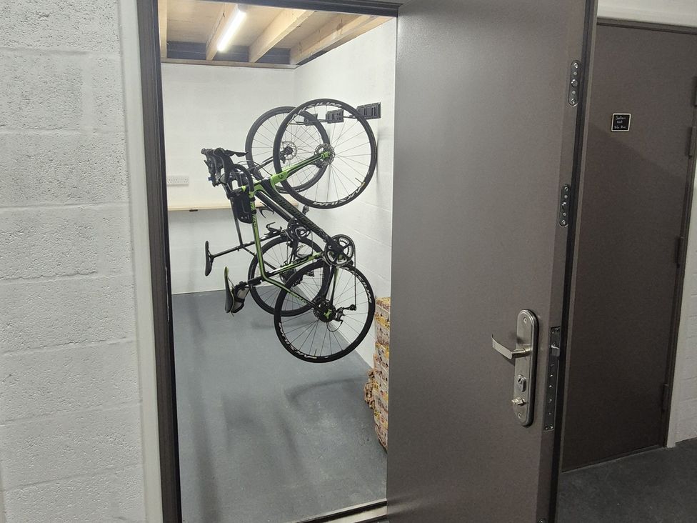 A storage room with a bike on a wall at Wren's Nest in Thornthwaite near Braithwaite