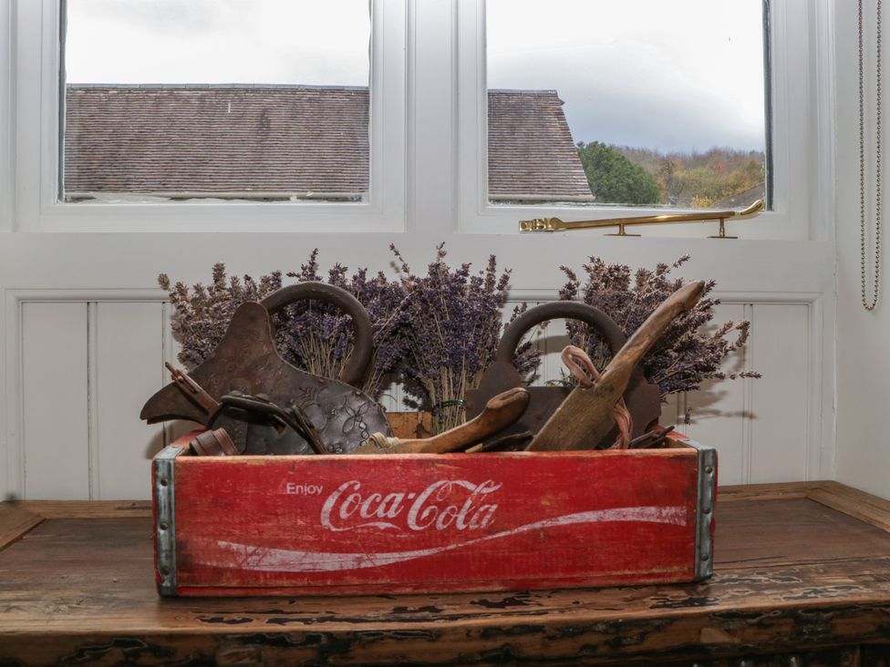 A basket with lavender and wooden items on a table at Cottage - 1 bedroom Broadway