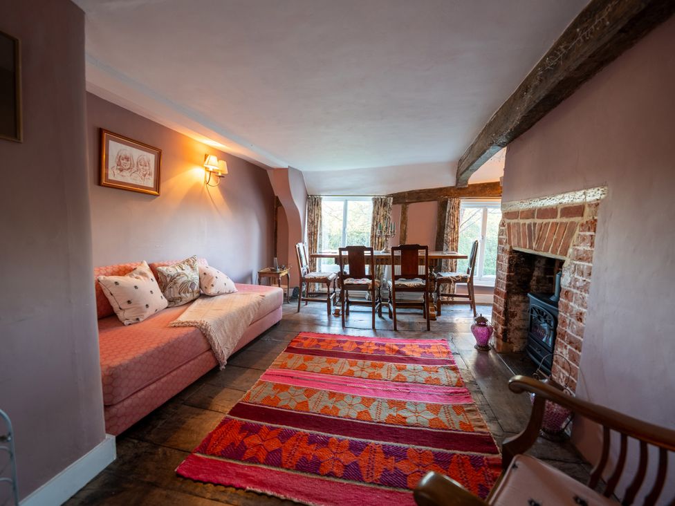 A living room with a sofa and dining table at 5 St. Michaels Close Framlingham