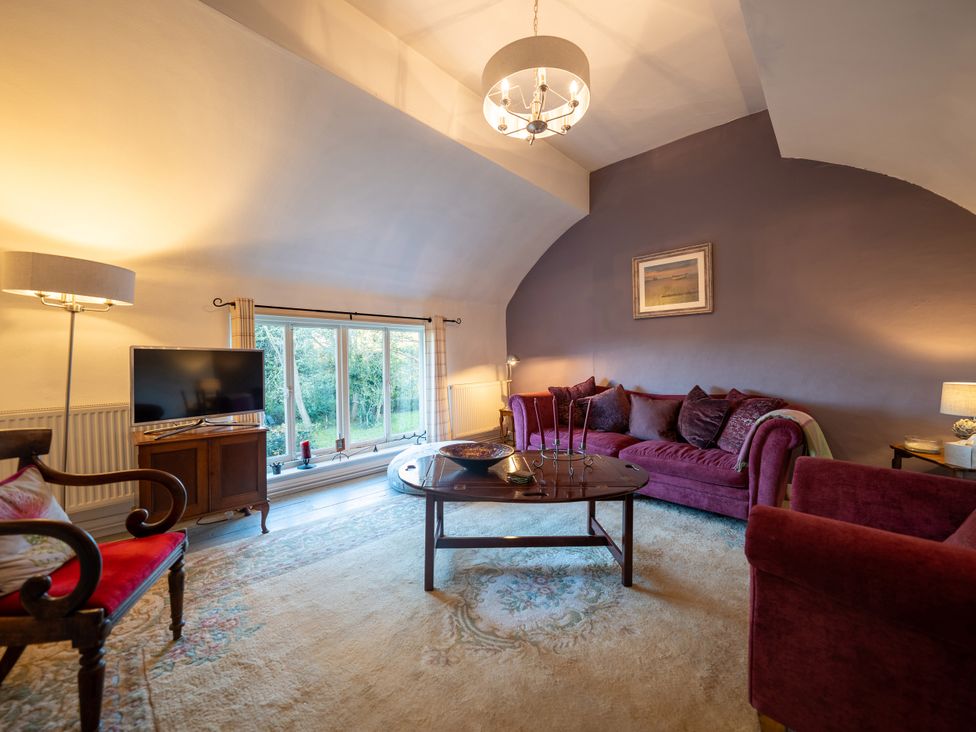 A living room with a sofa and television at 5 St. Michaels Close in Framlingham