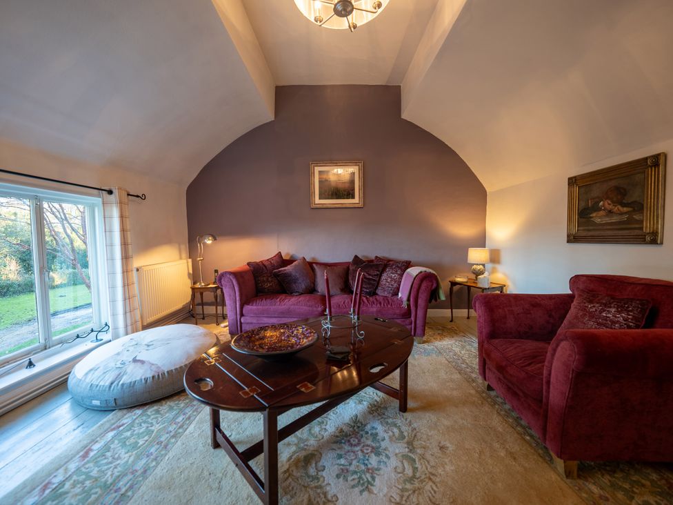 A living room with a sofa, armchair and coffee table at 5 St. Michaels Close in Framlingham