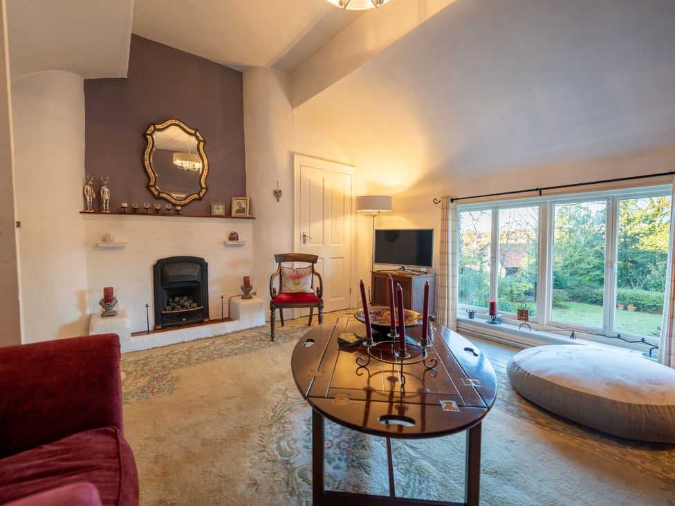 A living room with a fireplace and television at 5 St. Michaels Close in Framlingham