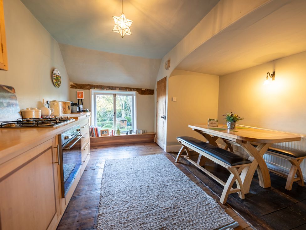 A kitchen with dining table and bench seating at 5 St. Michaels Close in Framlingham