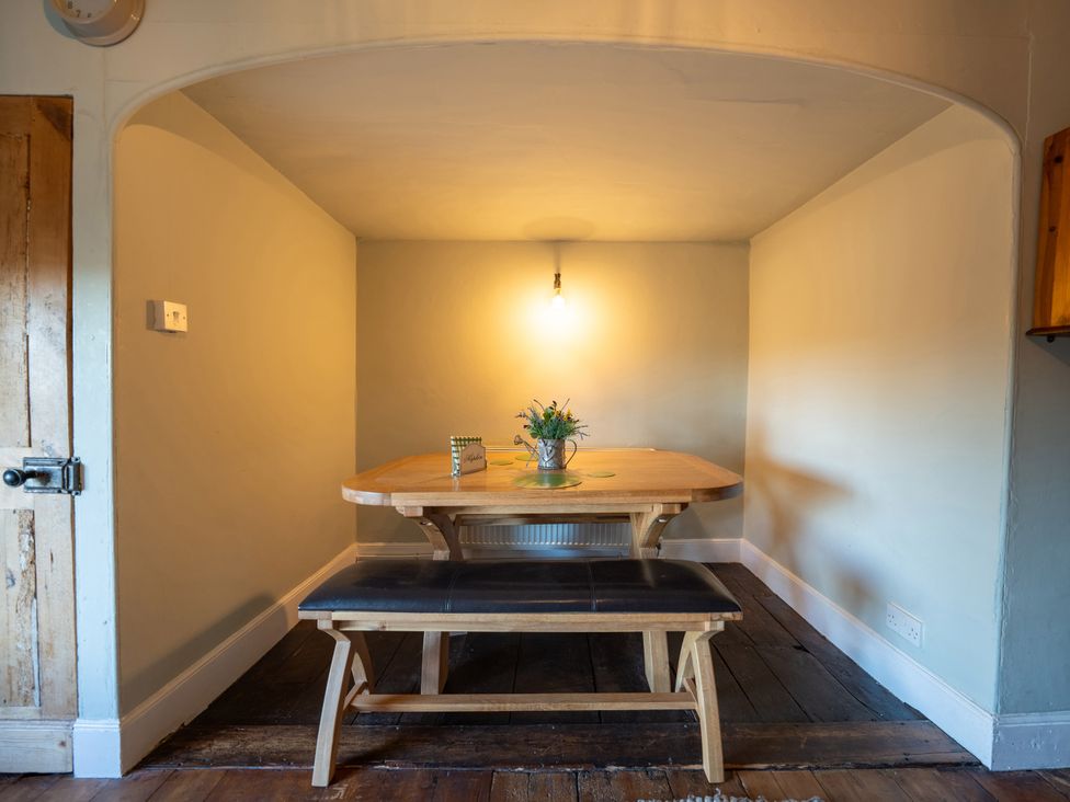 A dining room with a table and bench at 5 St. Michaels Close Framlingham