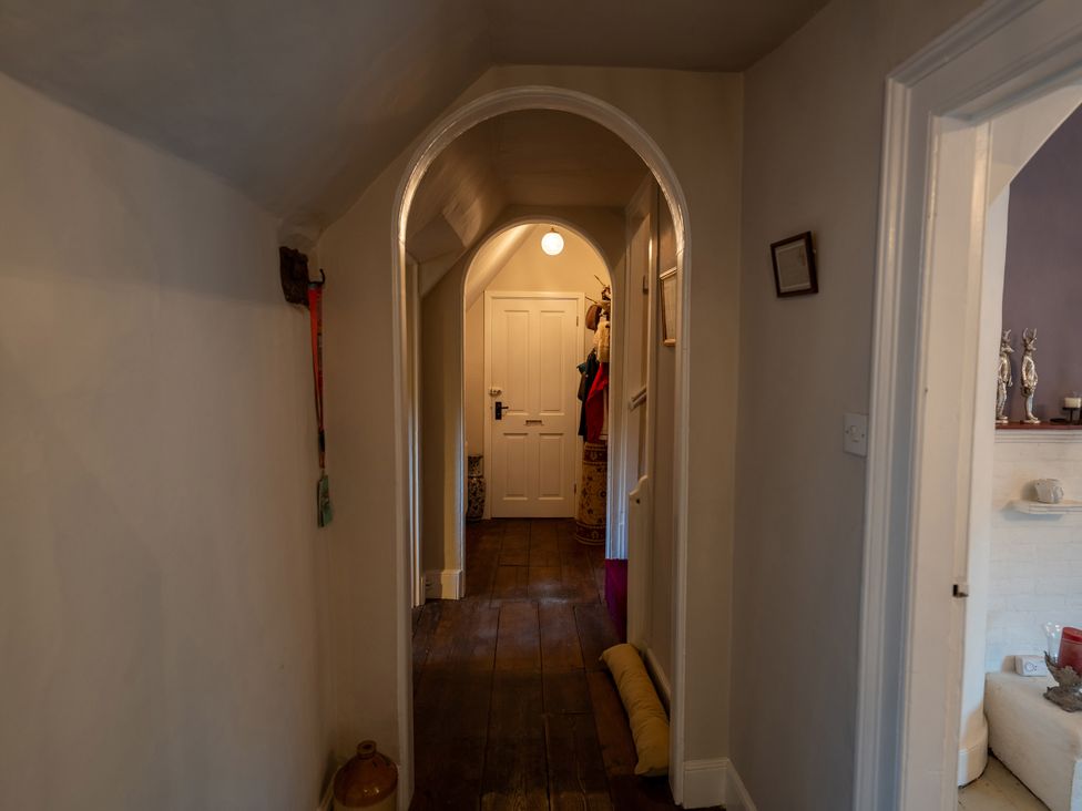 A hallway with a door and coat hooks at 5 St. Michaels Close Framlingham