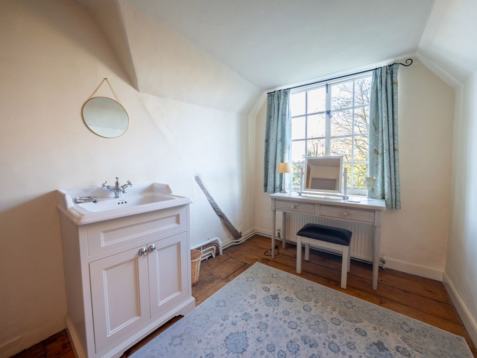 A bathroom with a sink and mirror at 5 St. Michaels Close Framlingham