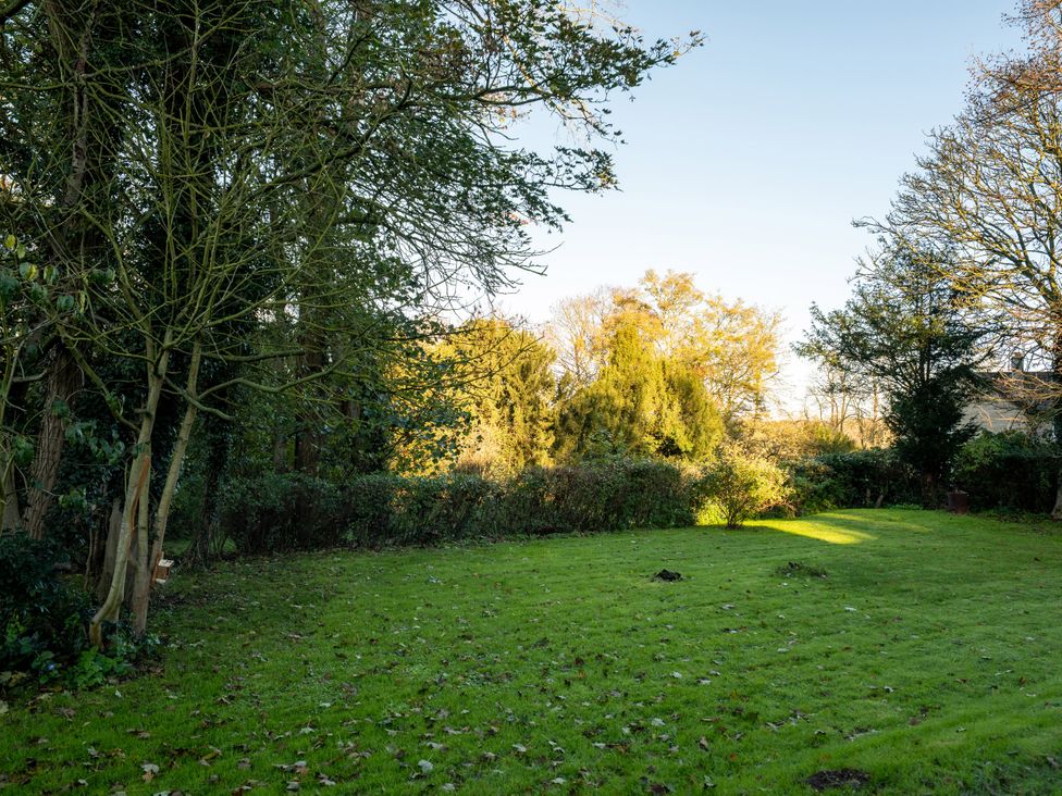 A garden with trees and grass at 5 St. Michaels Close Framlingham