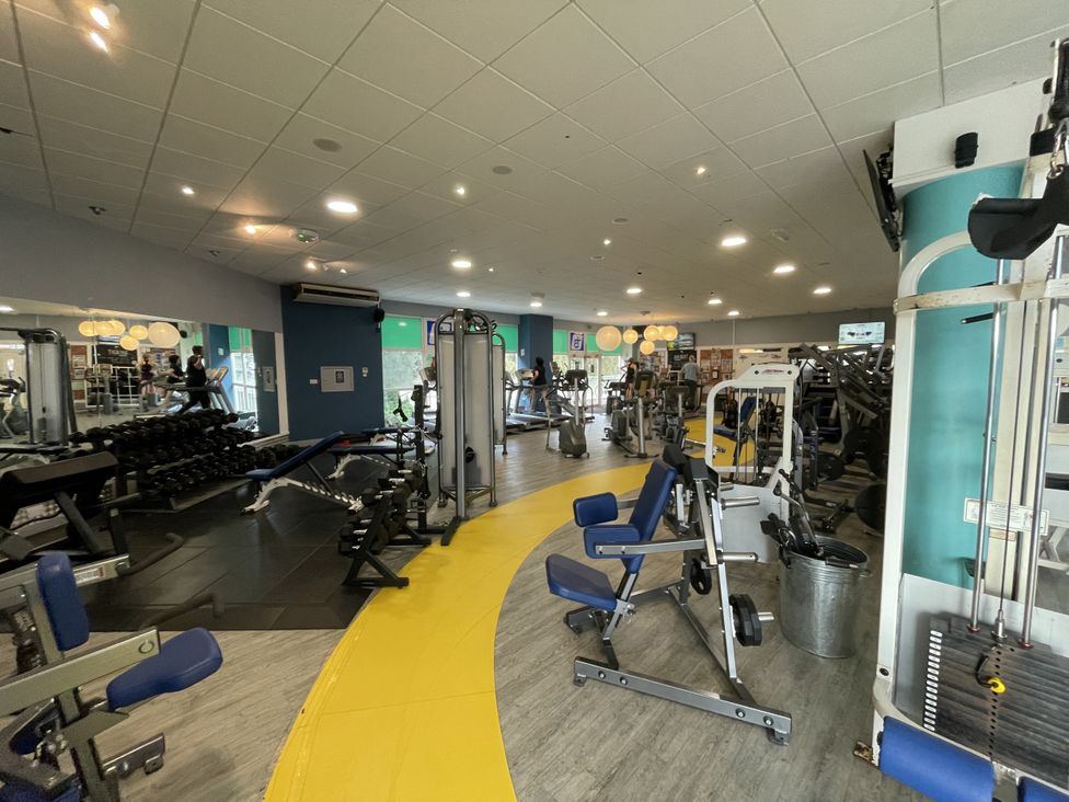 A gym area with various fitness equipment at Satinwood in White Cross near Newquay