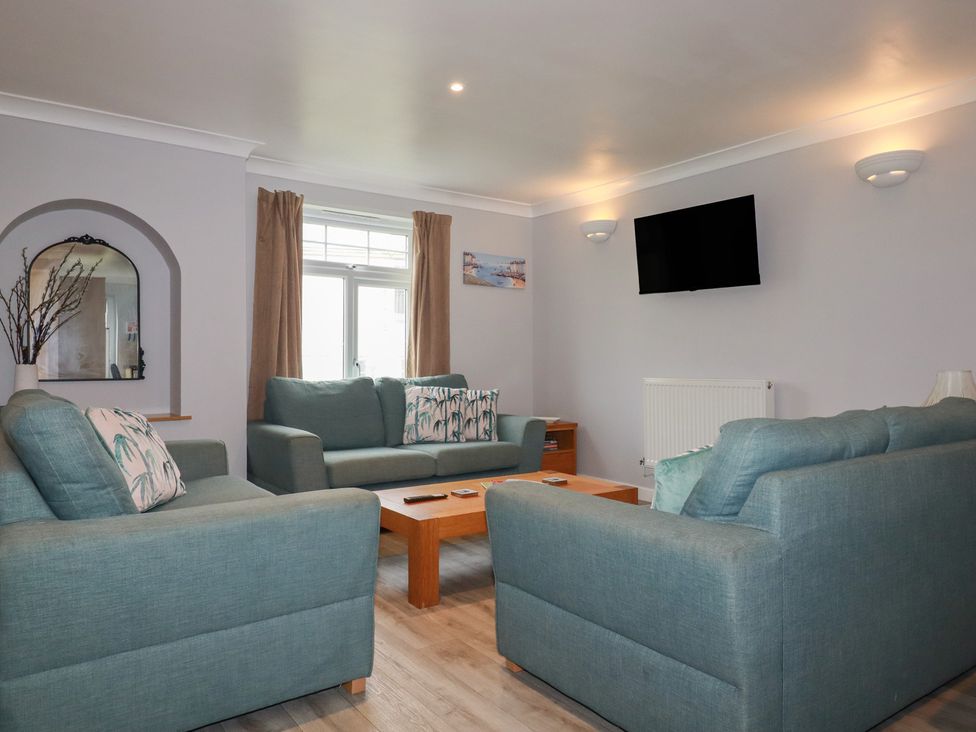 A living room with sofas and a television at Satinwood, White Cross near Newquay