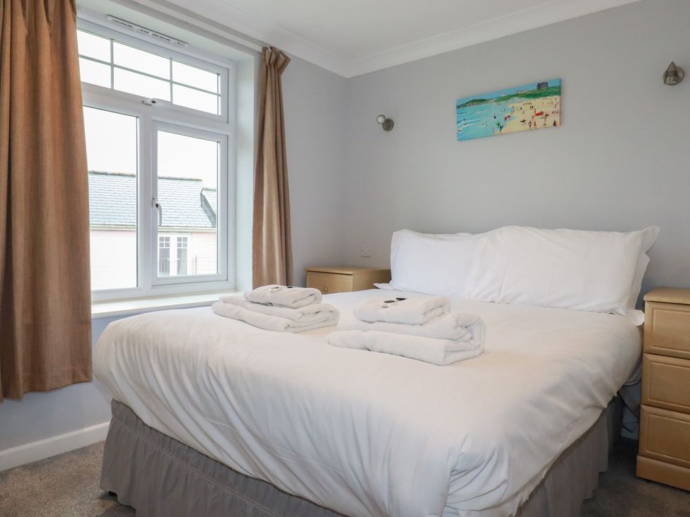 A bedroom with a bed and bedside tables at Satinwood in White Cross near Newquay