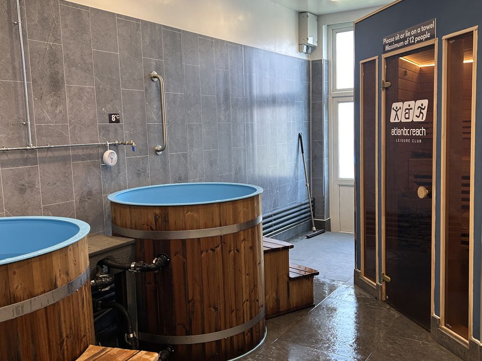 A spa area with wooden tubs and a sauna at Satinwood in White Cross near Newquay