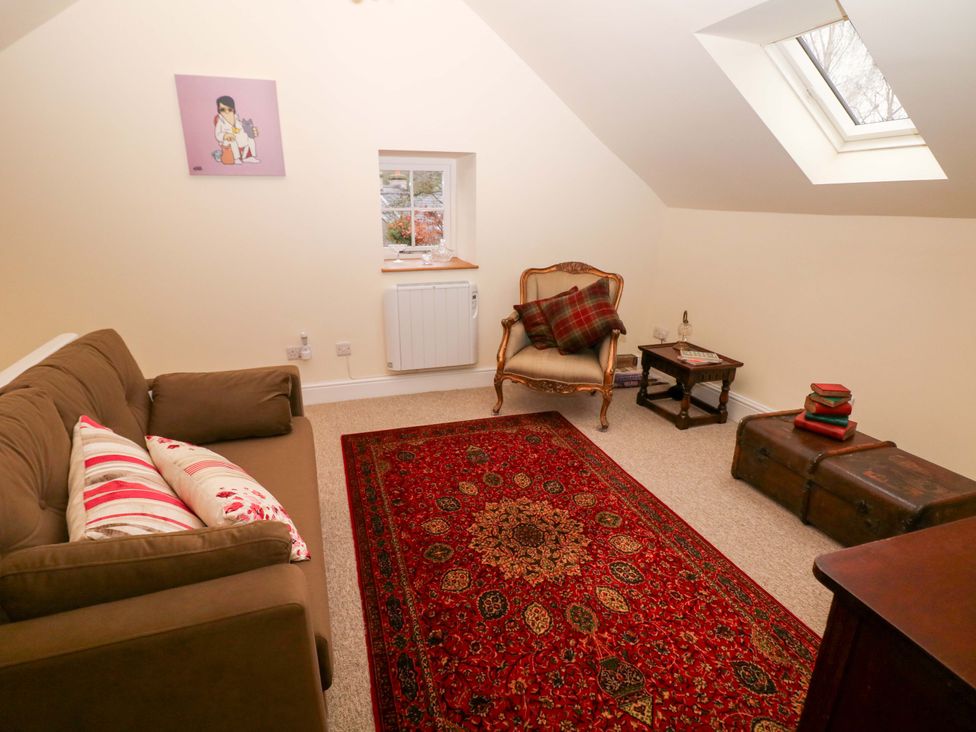 A snug with a sofa and chair at Laneside Barn Calver