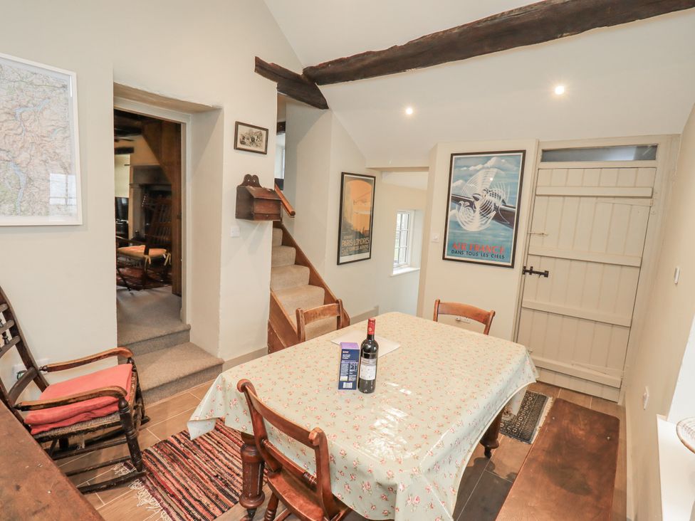 A dining room with a table and chairs at Old Cottage Oxen Park near Ulverston