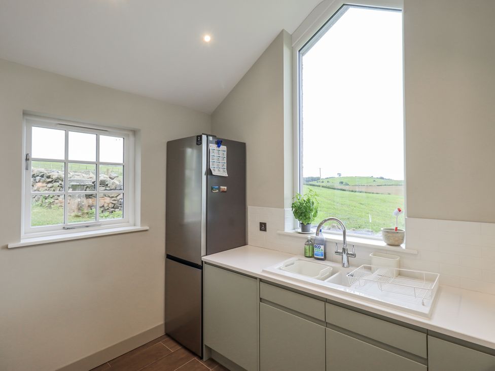 A kitchen with a refrigerator and sink at Old Cottage Oxen Park near Ulverston