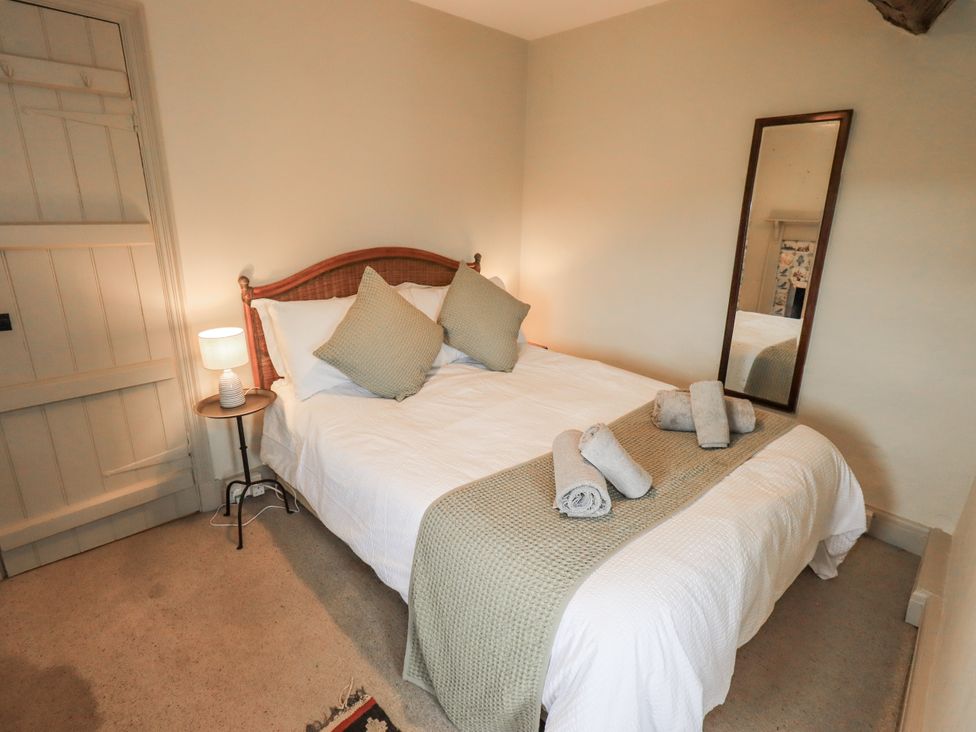 A bedroom with a bed and towels on it at Old Cottage in Oxen Park near Ulverston