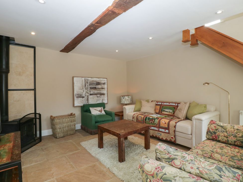 A living room with a coffee table and sofa at Stable Cottage in Broadway