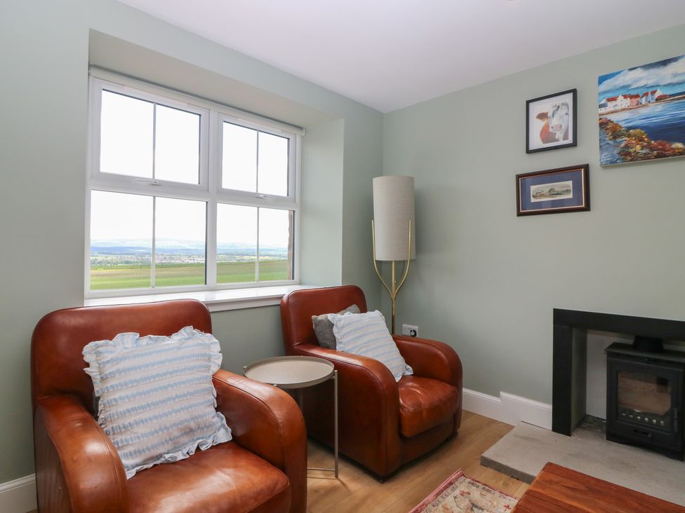 A living room with two armchairs and a fireplace at No 4 - 3 bed in Haddington