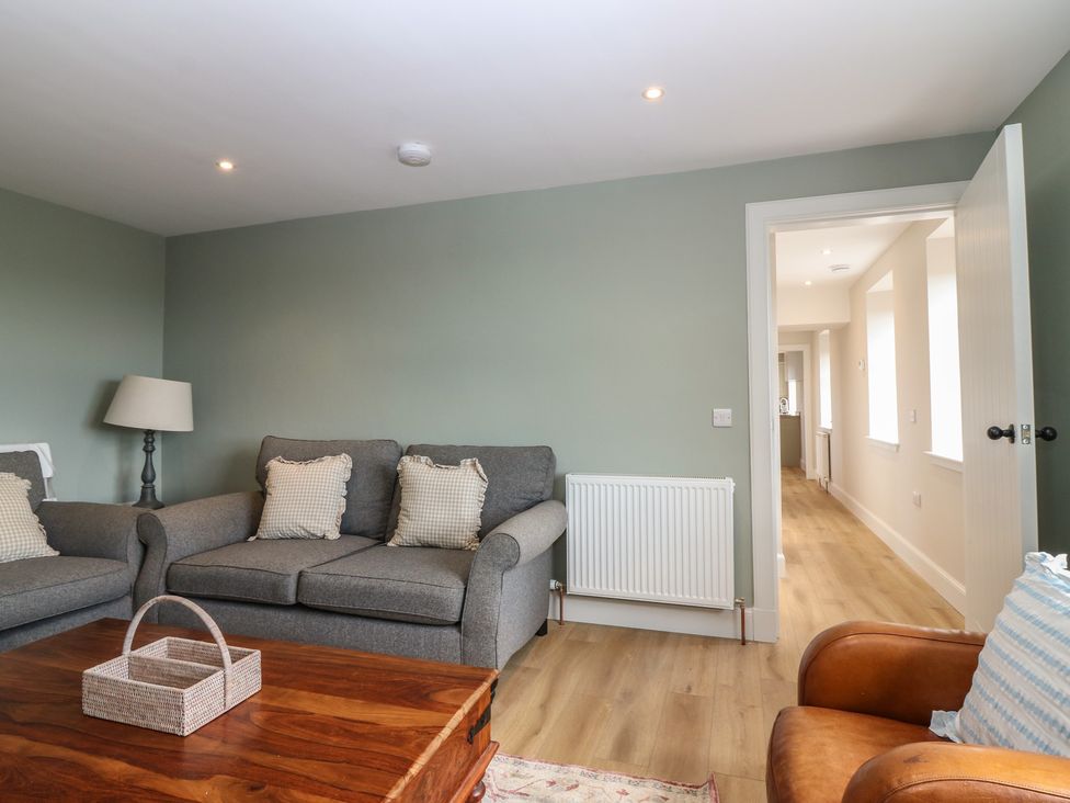 A living room with a sofa and armchair at No 4 - 3 bed Haddington