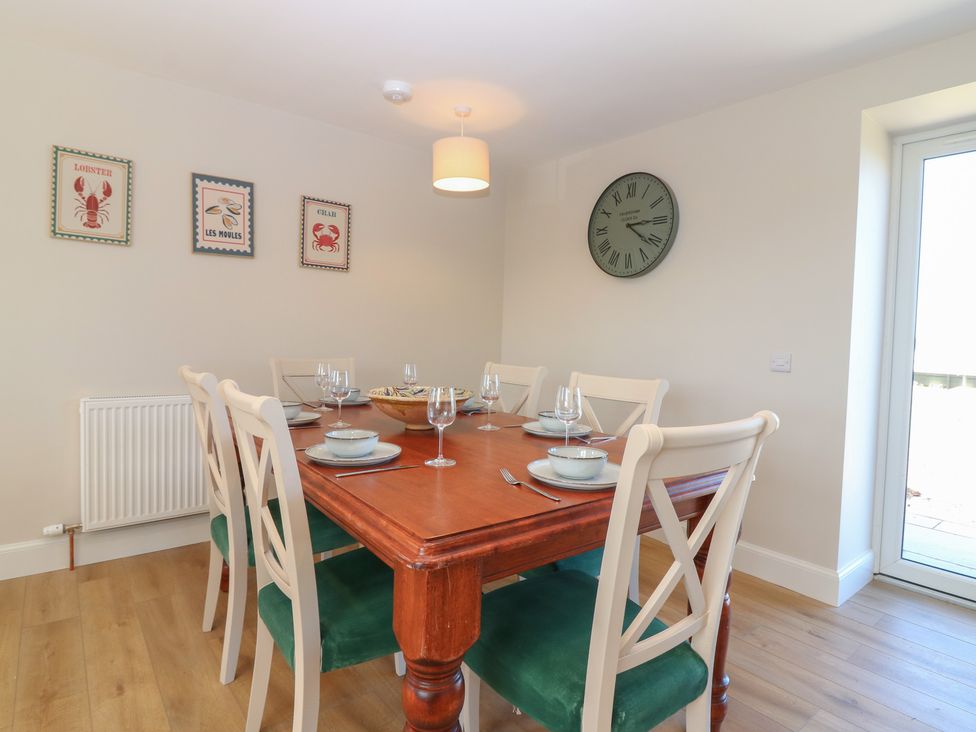 A dining room with a wooden table and chairs at No 4 - 3 bed in Haddington