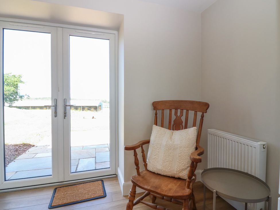 A seating area with a rocking chair and side table at No 4 - 3 bed Haddington