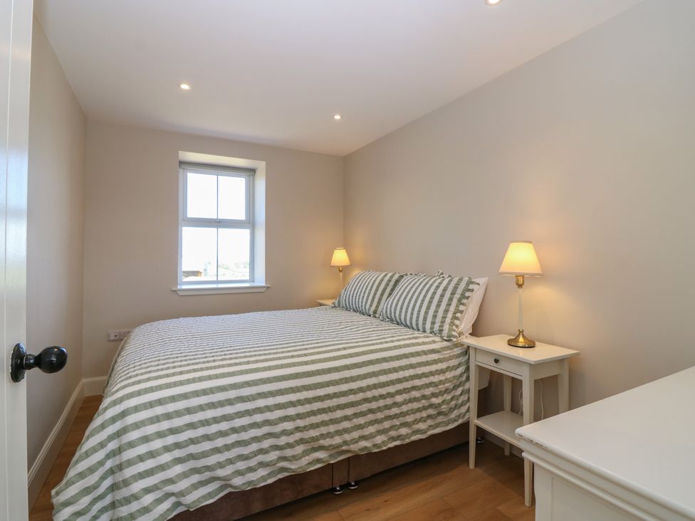 A bedroom with a bed and nightstands at No 4 - 3 bed Haddington