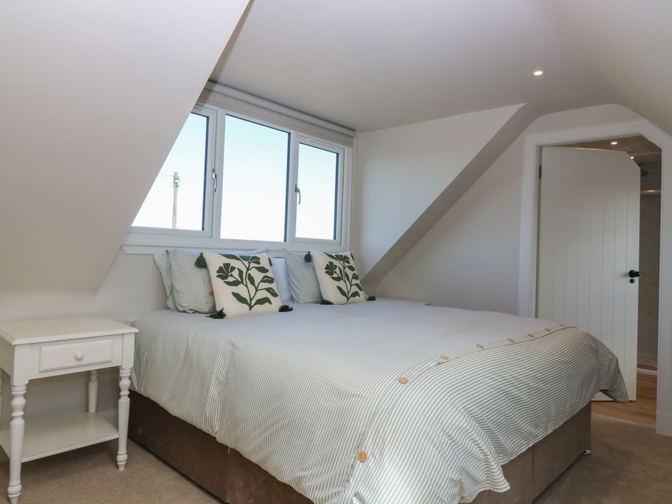 A bedroom with a bed and bedside table at No 4 - 3 bed, Haddington