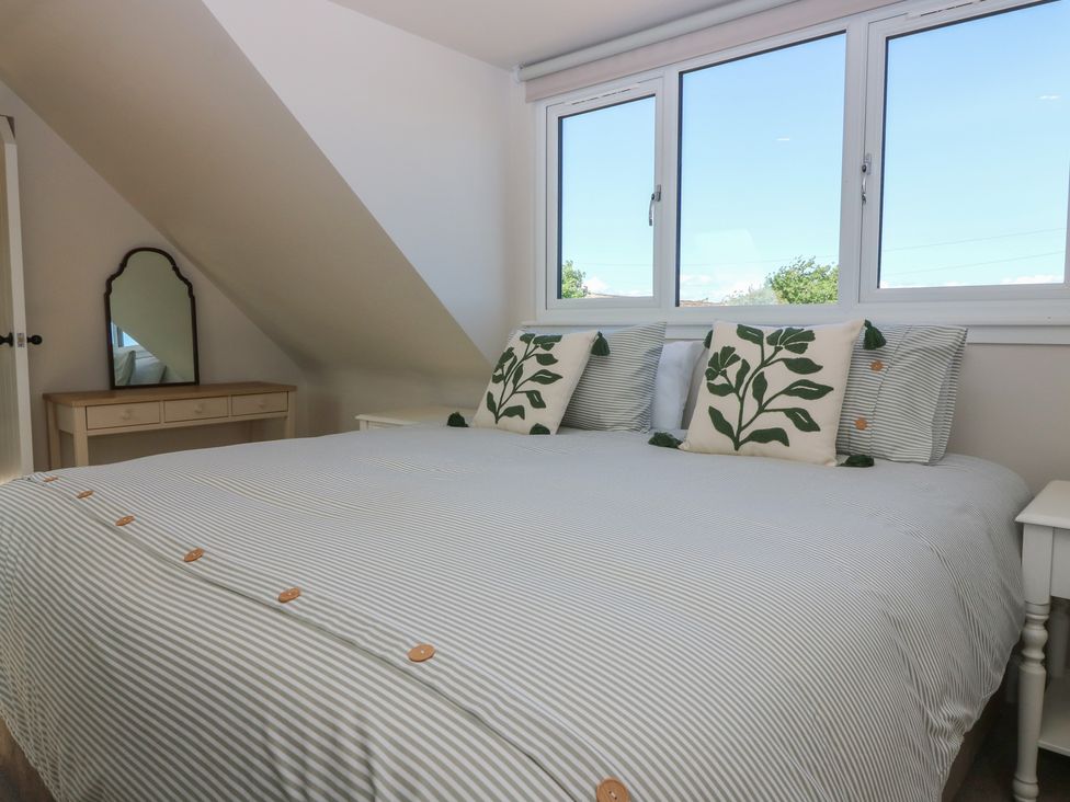 A bedroom with a bed and mirror at No 4 - 3 bed Haddington