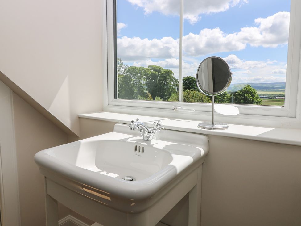 A bathroom with a sink and mirror at No 4 - 3 bed Haddington