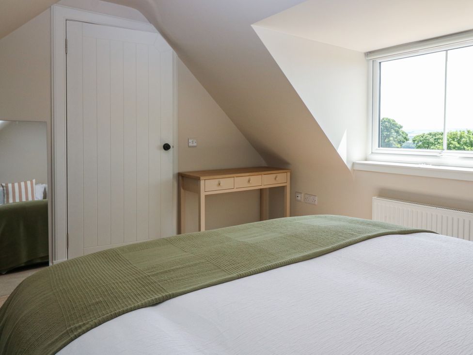 A bedroom with a desk and window at No 4 - 3 bed Haddington