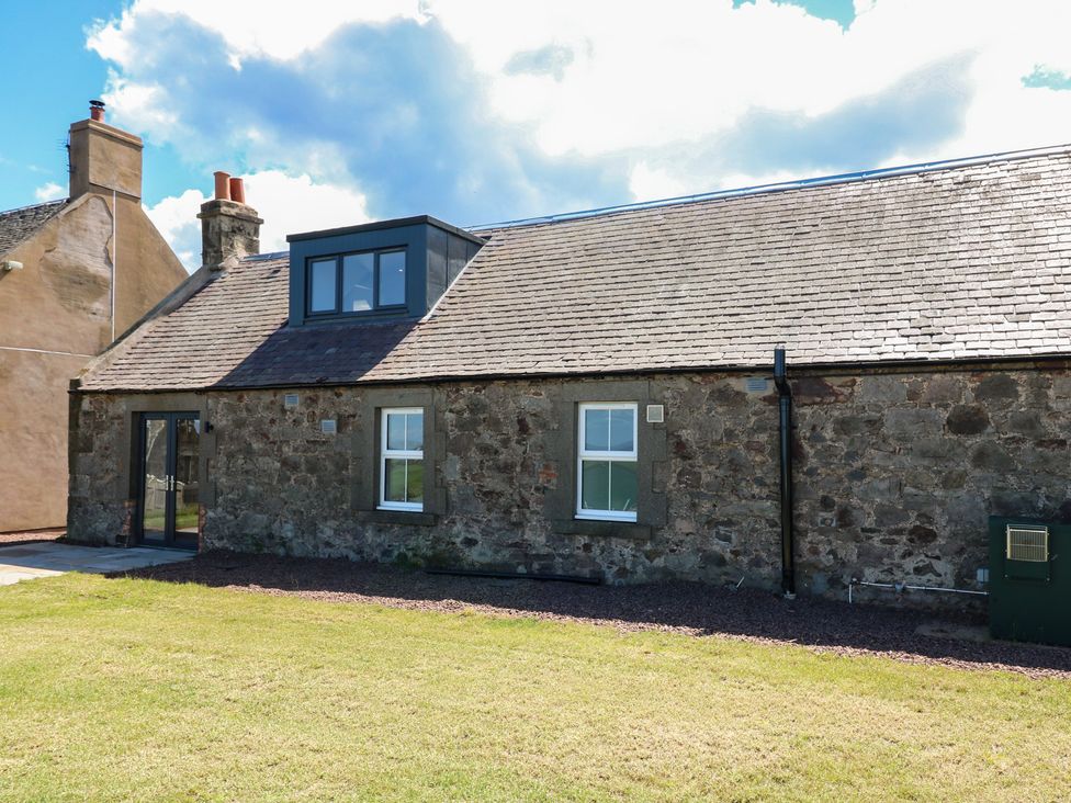 A stone building with windows and a door in the garden at No 4 - 3 bed Haddington