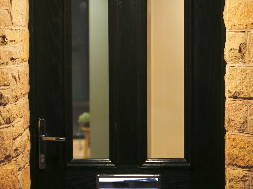 A door with a handle and brick surround at Havendale in Chesterfield