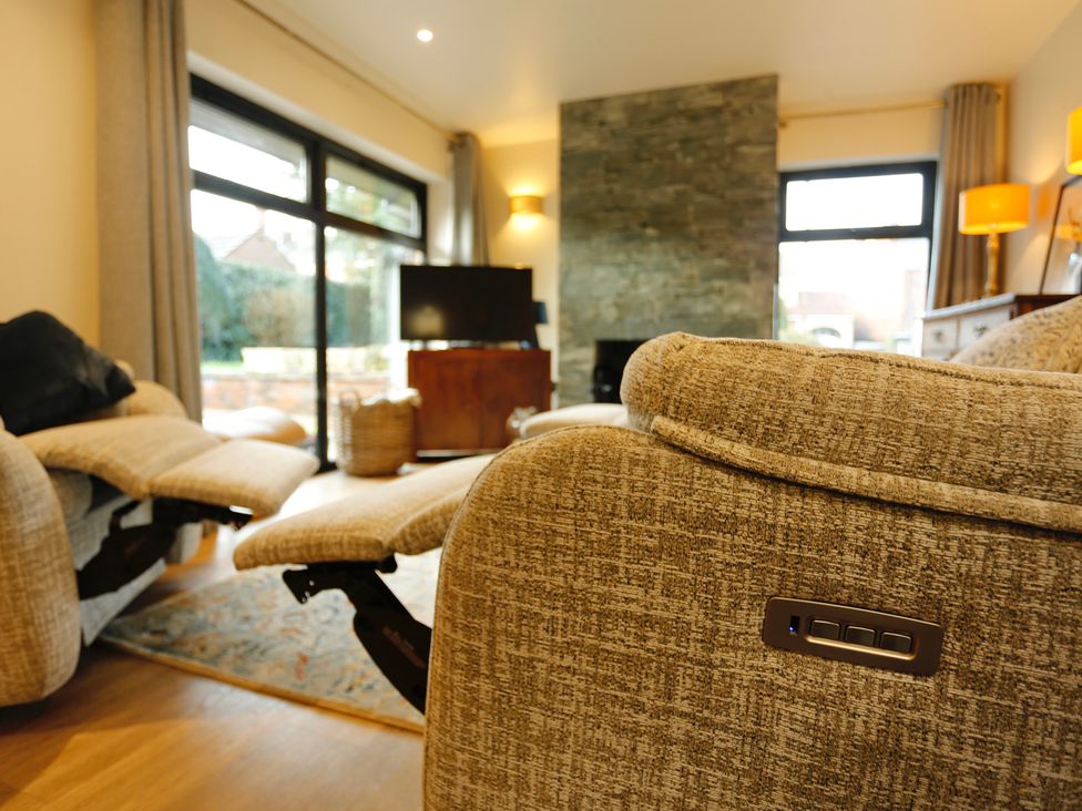 A living room with a recliner and a television at Havendale in Chesterfield