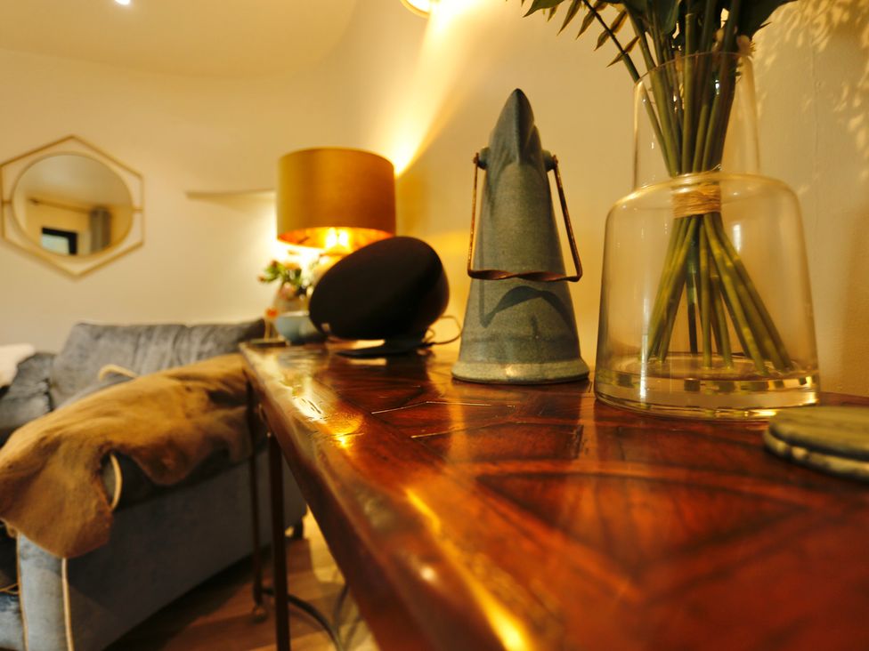 A living room with a lamp and plants on a table at Havendale in Chesterfield