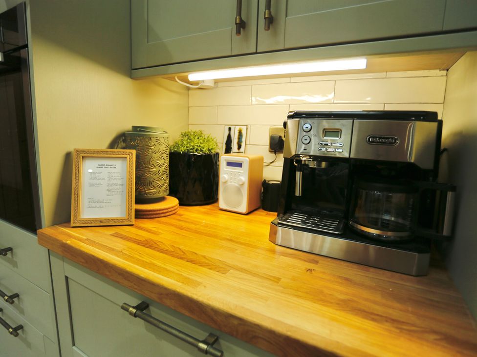 A kitchen counter with a coffee machine and radio at Havendale, Chesterfield