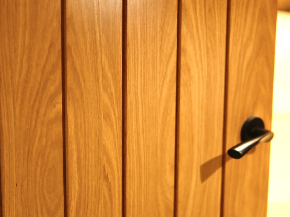 A wooden door with a black handle at Havendale Chesterfield
