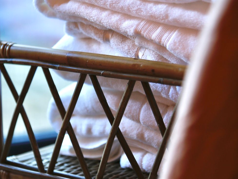 Towels stacked on a rack in the bathroom at Havendale in Chesterfield
