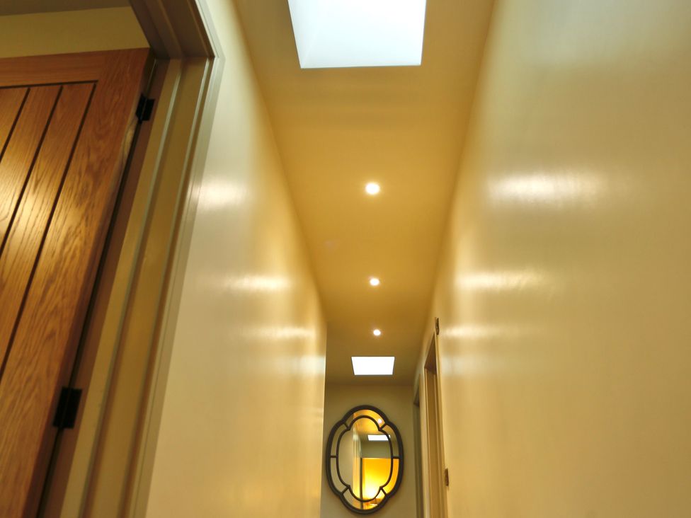 A hallway with a door and mirror at Havendale Chesterfield