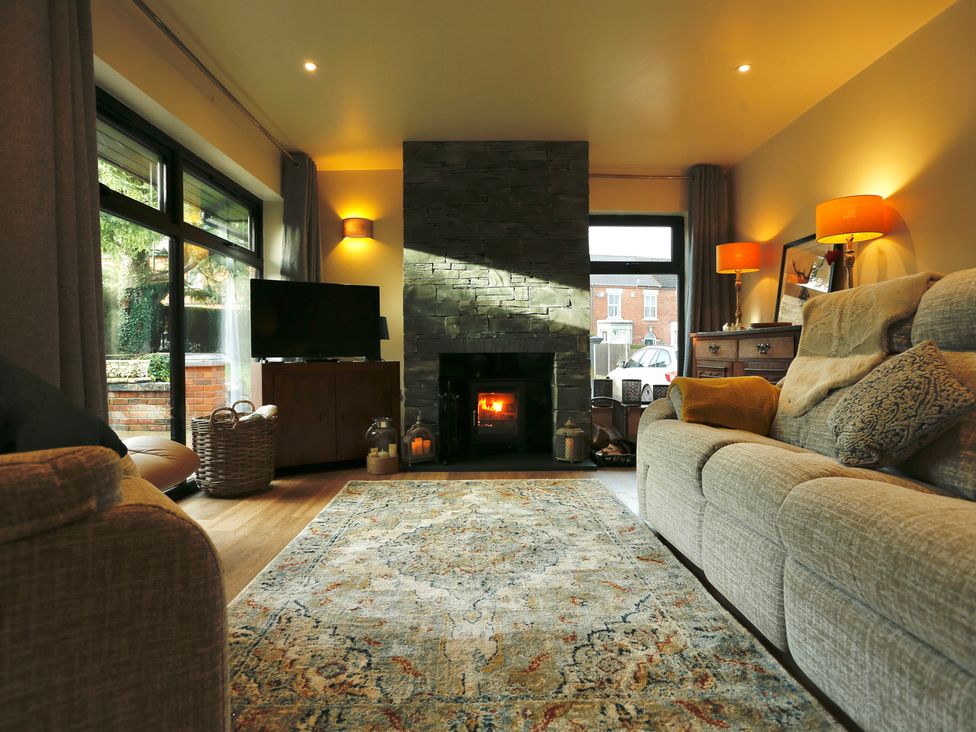 A living room with a fireplace and television at Havendale in Chesterfield