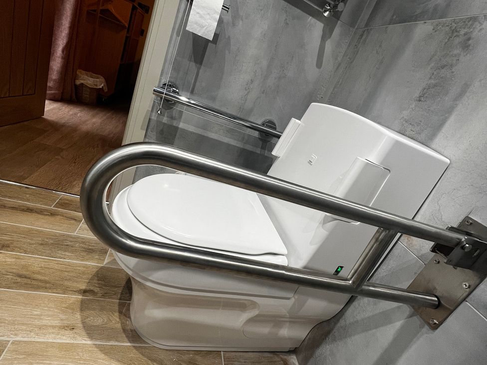 A bathroom with a toilet and grab bar at Havendale in Chesterfield