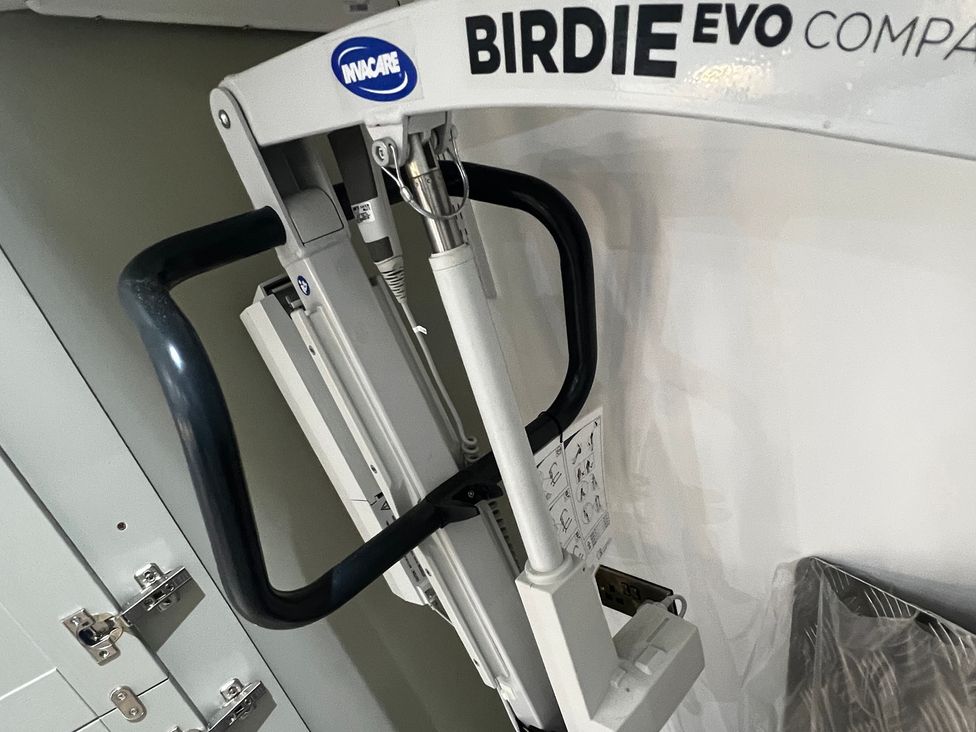A patient lifter with control buttons and support handles at Havendale in Chesterfield