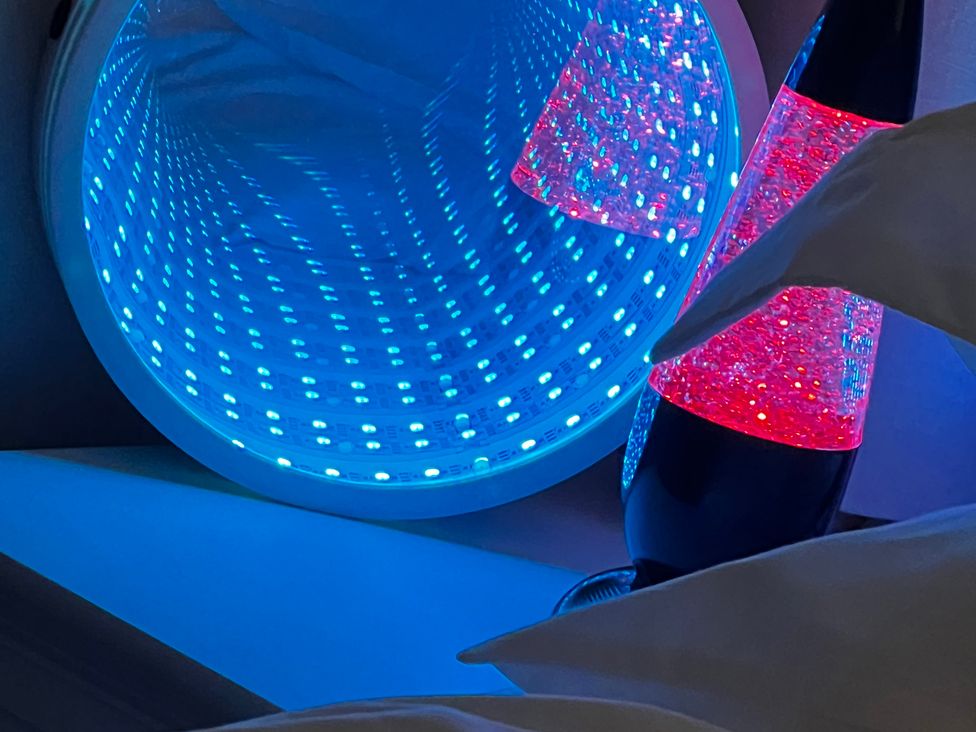 A bedside scene with a blue light and a lava lamp at Havendale Chesterfield