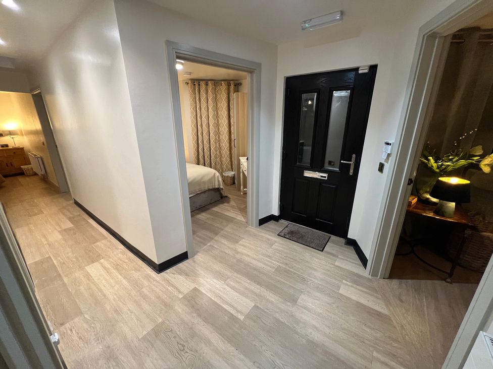 A hallway with a door and bedroom entrance at Havendale Chesterfield