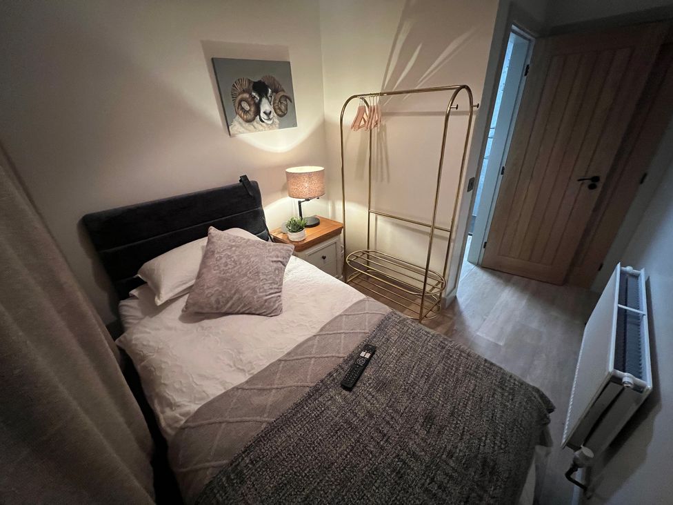 A bedroom with a bed and clothes rack at Havendale in Chesterfield