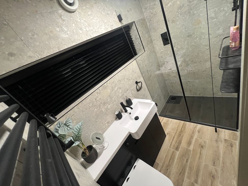 A bathroom with a sink shower and towel rack at Havendale, Chesterfield