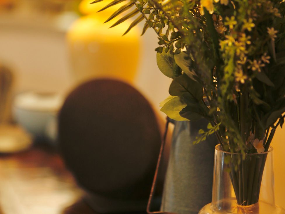 A dining area with flowers in a vase at Havendale in Chesterfield