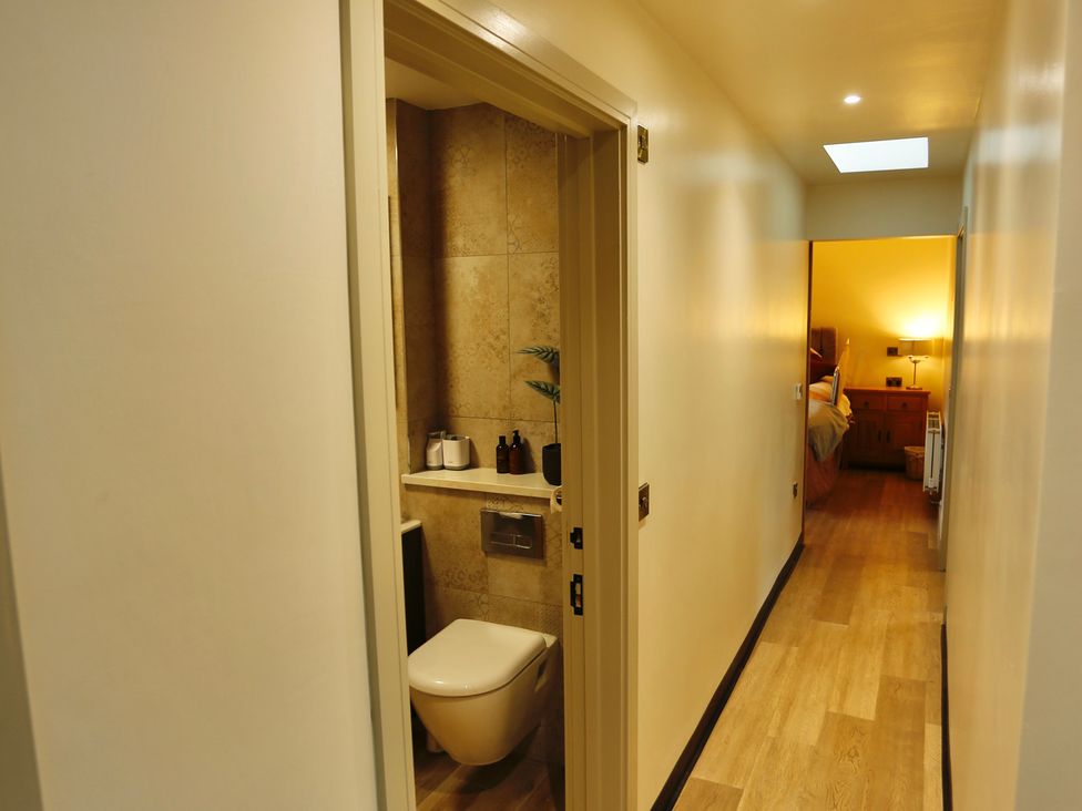 A hallway with a toilet and sink at Havendale in Chesterfield