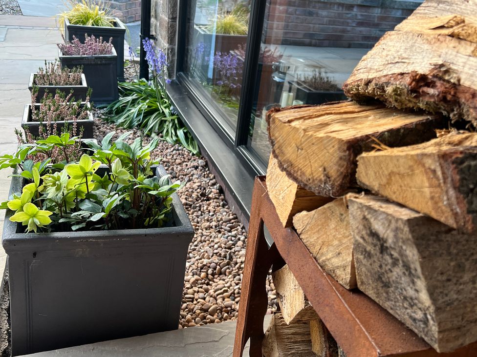 Planters with plants and wood stack at Havendale in Chesterfield