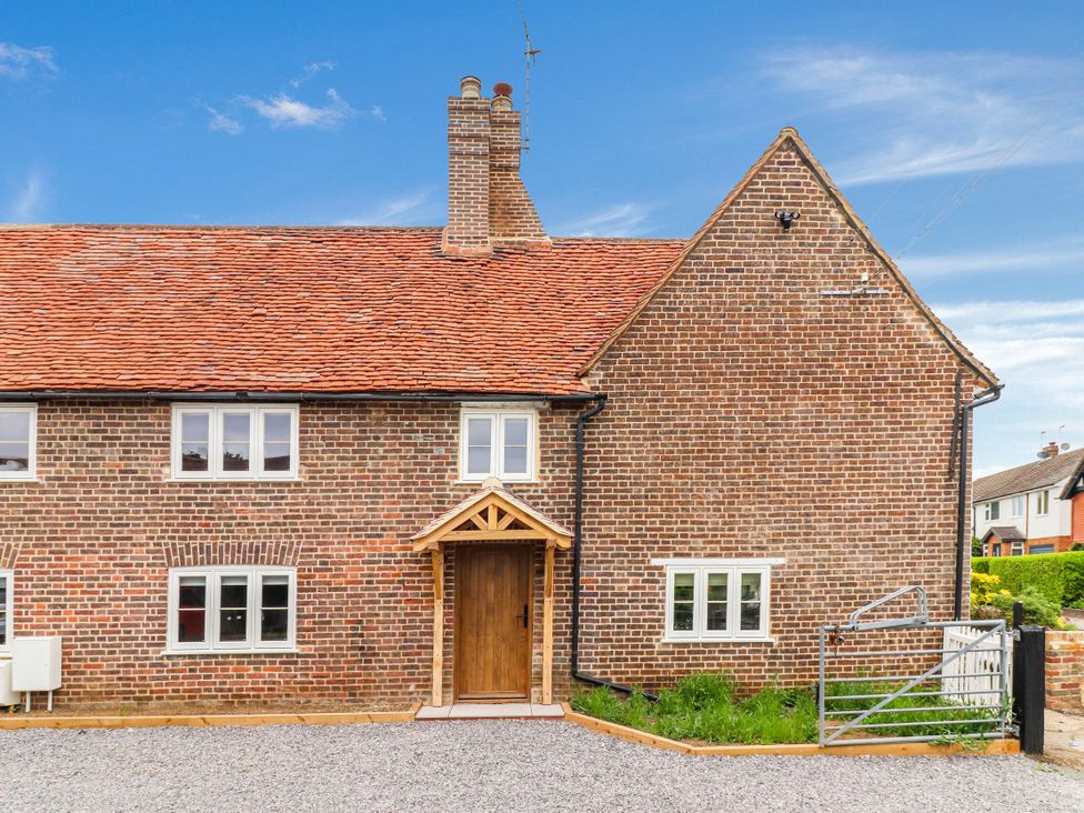 A house with a wooden door and windows at Tuffs Farm Cottage 1 Kings Langley