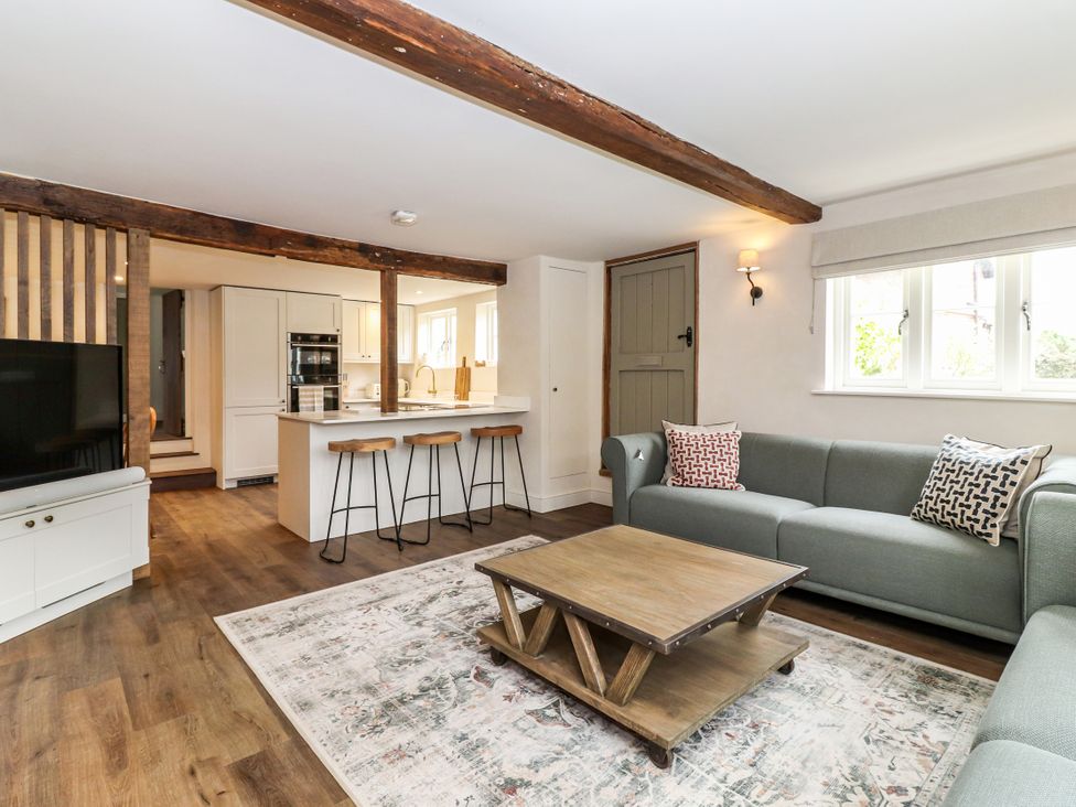 A living room with a sofa and coffee table at Tuffs Farm Cottage 1 Kings Langley
