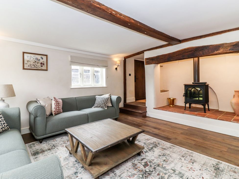A living room with a sofa and coffee table at Tuffs Farm Cottage 1 in Kings Langley